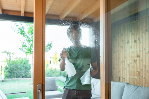 istock Diligent Asian Man Engaged in Home Window Cleaning 2171703439