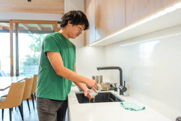 istock Asian Man Washing Dishes in Home Kitchen 2171703466