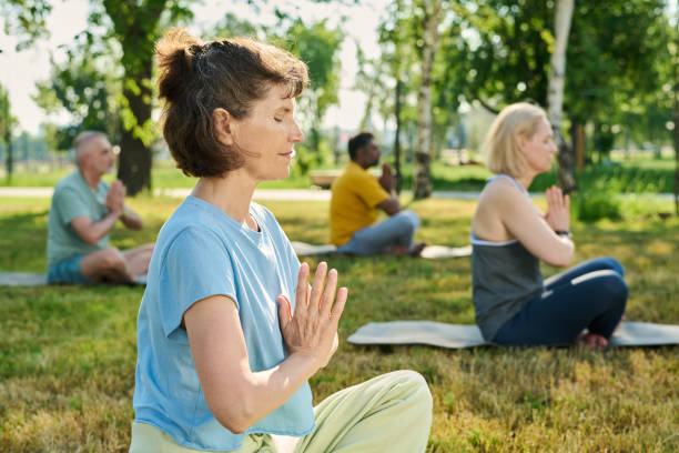 istock Mature serene woman doing yoga exercise 2171703686