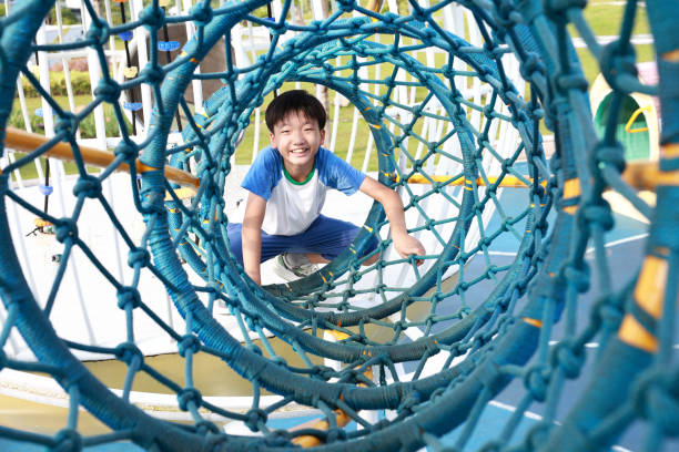 istock Little boy climbing rope trail 2171703703
