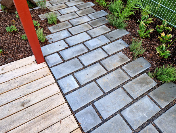 istock flat stones in the garden form a footpath with a bed mulched with bark chips. stepping stones in two rows guide visitors to the park 2171703888
