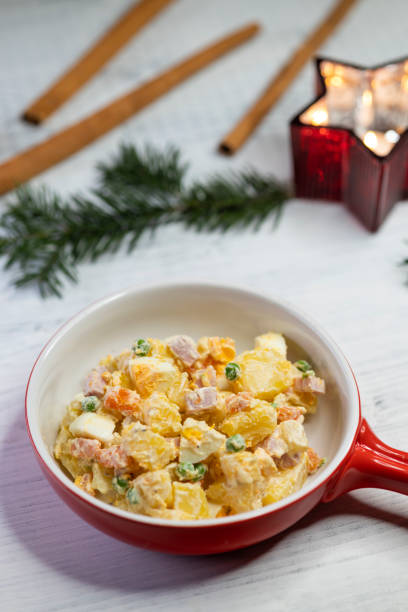 Christmas Eve vegetable salad with boiled potatoes, carrots, parsley, apple and cucumber in mayonnaise sauce