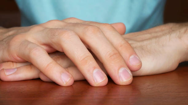 istock Close up of man's hands folded on a wooden table 2171705924