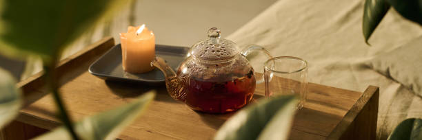istock Teapot, empty glass and burning candle 2171707227