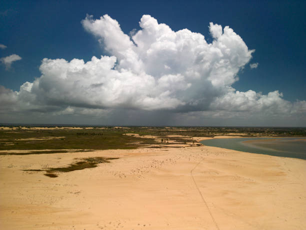 Cumulus nimbus rain cloud over the mouth of the São Francisco River on the border between the states of Alagoas and Sergipe on the northeast coast of Brazil