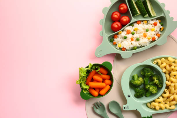 istock Baby feeding tableware with lunch on pink background. Flat lay, top view. 2171713352