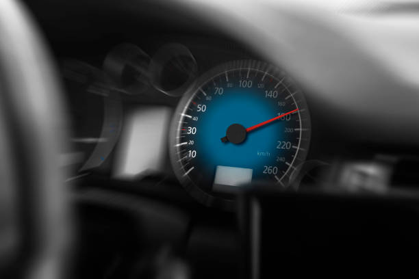 A speedo of a car begging to go faster. (it did, it did) focus on dials, steering out of focus