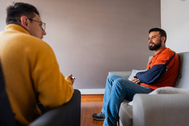 istock Mid adult man talking with psychologist during therapy session 2171720724