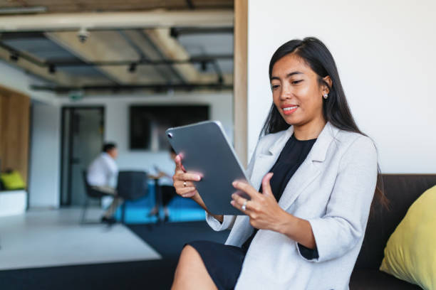 istock Asian Businesswoman Using Digital Tablet in Office 2171722147