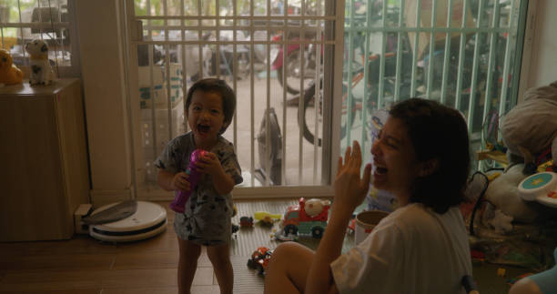 istock Asian son and mom singing a song with microphone toy. 2171722691