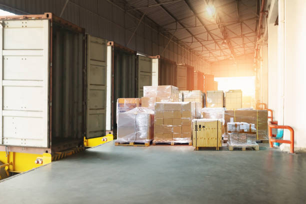 istock Bulk Pallets of Package Boxes Wrapped Plastic Stacked on Pallets. Trucks Loading at Warehouse Dock. Distribution Warehouse Shipping, Supply Chain Supplies, Shipment. Freight Truck Logistics Transport. 2171722846