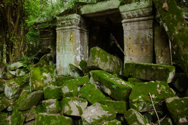 istock Ancient Angkor Wat ruins engulfed by lush greenery and moss in Cambodia during golden hour 2171724552