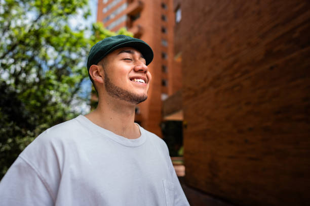 Happy young man contemplating outdoors