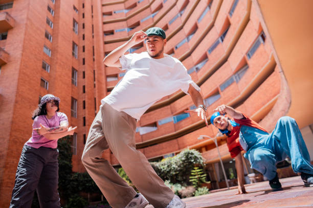 Young man dancing with friends outdoors