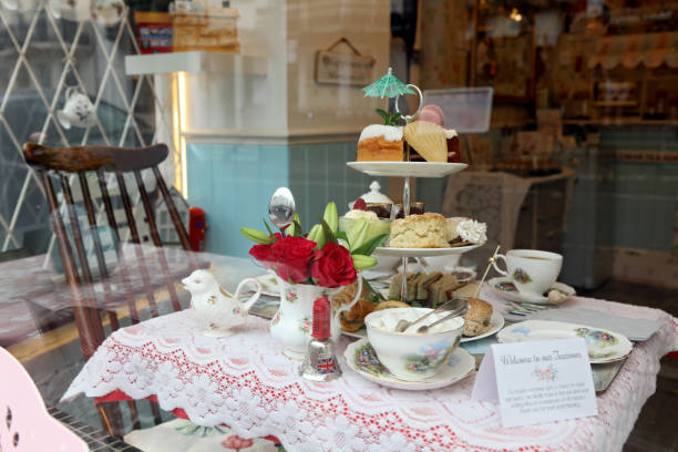 An elegant spread of traditional English afternoon tea, featuring classic finger sandwiches, scones with clotted cream and jam, and a selection of fine teas. A timeless British tradition.