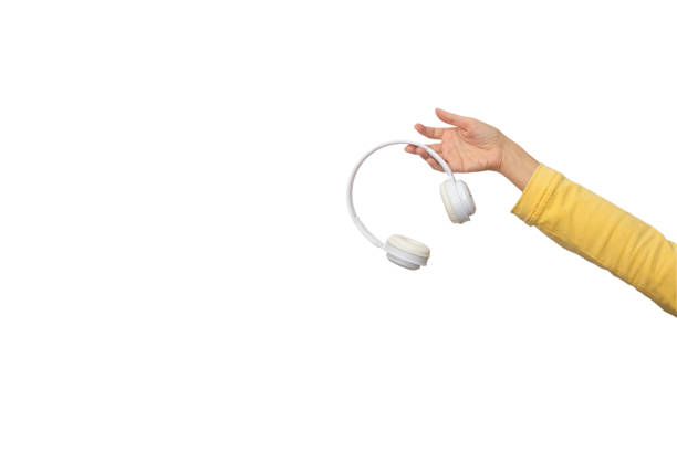 istock White wireless headphones in female hand isolated on white background, copy space 2171727471
