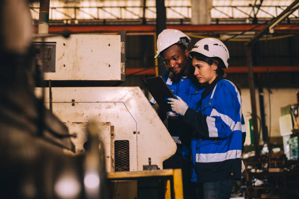 istock Technician looking at circuit board, cutting machine, milling machine, lathe, experimenting with electronics in industrial factory 2171727753