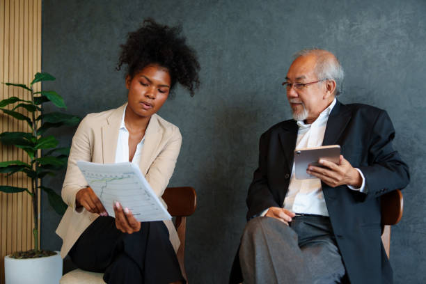 istock Two business colleagues of different ages are discussing project documents in an office. 2171727839