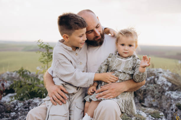 istock Father Enjoying Quality Time with His Children in Nature Setting 2171728234