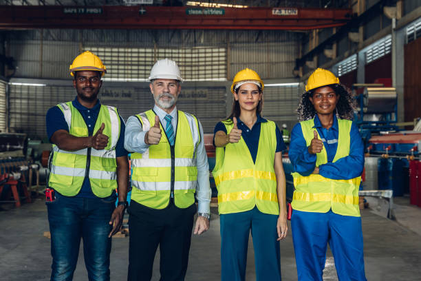 istock Worker standing in the factory. Group Staff Standing In Engineering Factory. Diverse multiethnic worker in manufacturing factory 2171729209