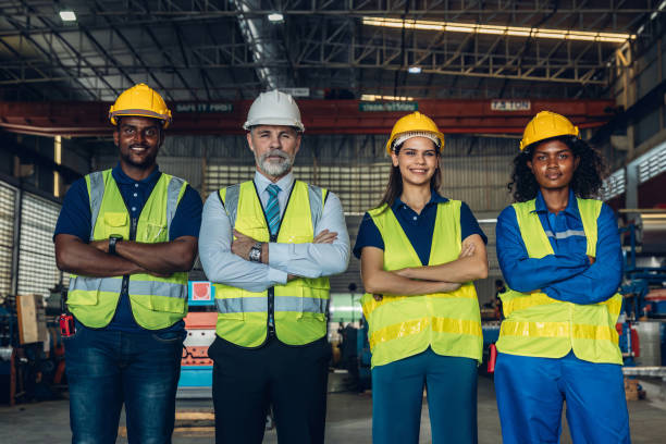istock Worker standing in the factory. Group Staff Standing In Engineering Factory. Diverse multiethnic worker in manufacturing factory 2171729211