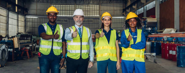 istock Worker standing in the factory. Group Staff Standing In Engineering Factory. Diverse multiethnic worker in manufacturing factory 2171729230