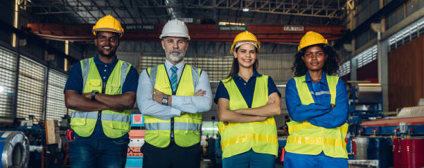 istock Worker standing in the factory. Group Staff Standing In Engineering Factory. Diverse multiethnic worker in manufacturing factory 2171729236