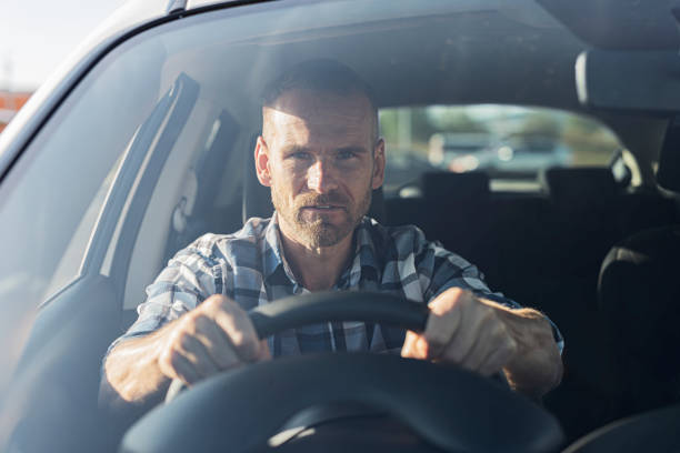 istock The driver is a young attractive man driving a car. 2171730896