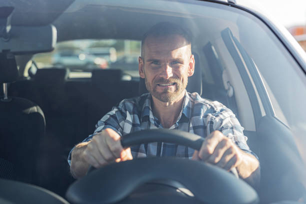 istock The driver is a young attractive man driving a car. 2171730908