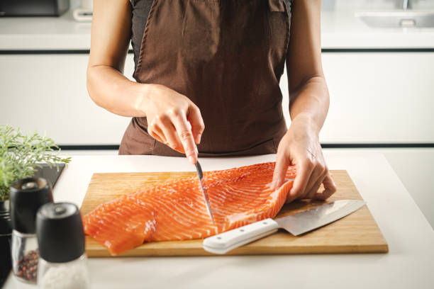 istock Women hold a raw salmon fillet 2171732091