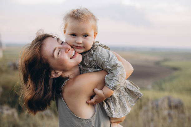 istock Mother Joyfully Embracing Her Young Daughter in a Serene Countryside Setting 2171734915