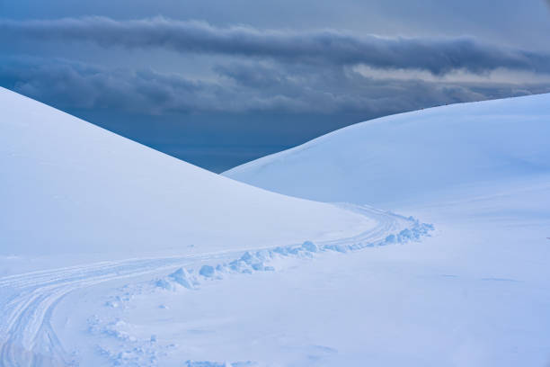 White glacier mountain with snow covered and snowmobile track on summit in winter at Iceland