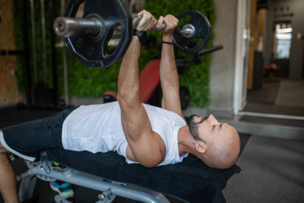istock Young man exercising in the gym. 2171740721