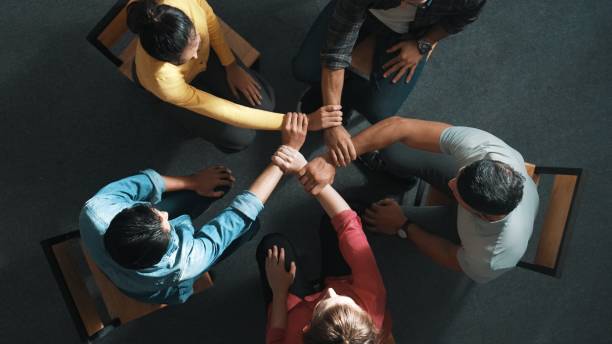 istock Top view of smart business people hold wrist while sitting circle. Symposium. 2171746007