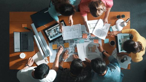 istock Top view of engineer team holding blueprint and standing at table. Symposium. 2171746653