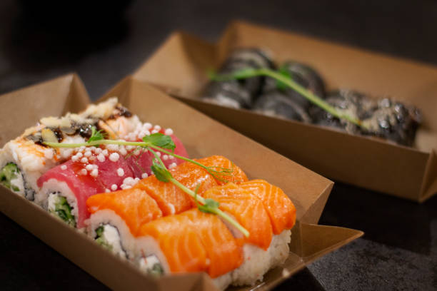 Sushi food delivery in the cartoon plate. With ingredients such as salmon, red tuna and shrimp