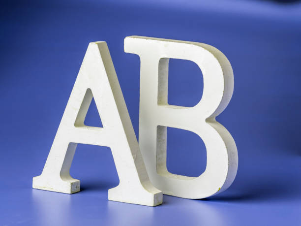 Wooden uppercase letters A and B on a colored background