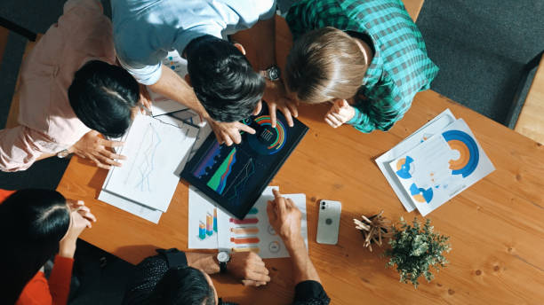 istock Top down view of business people analyze data together at meeting. Convocation. 2171749769
