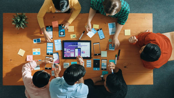 istock Top view of skilled business team writing idea on sticky note. Convocation. 2171751052