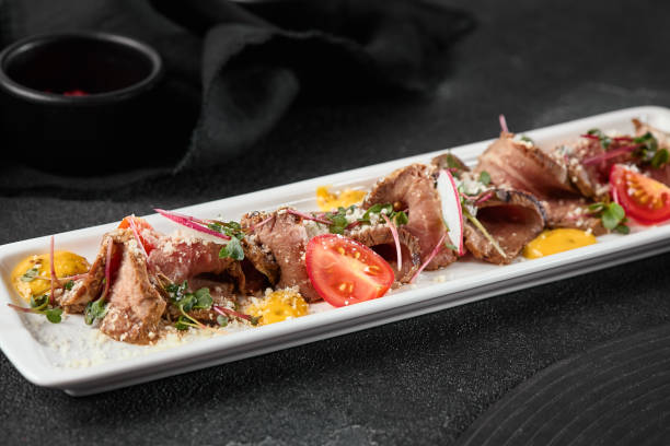 istock Gourmet Beef Roast Beef Platter with Tomatoes and Microgreens in Elegant Fine Dining Presentation 2171756892