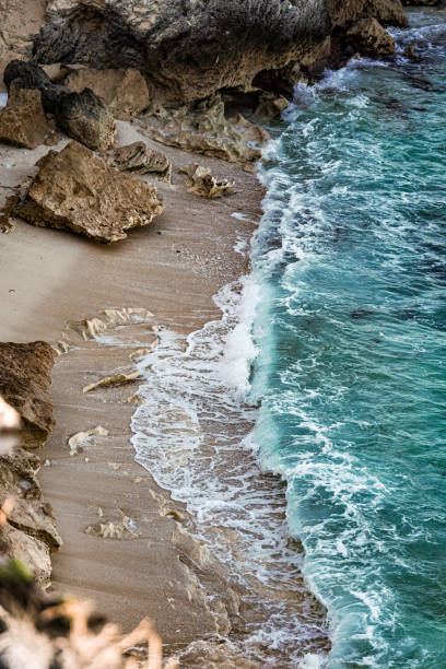 Blue waves from above the cliff with a drone, cold colors refreshing