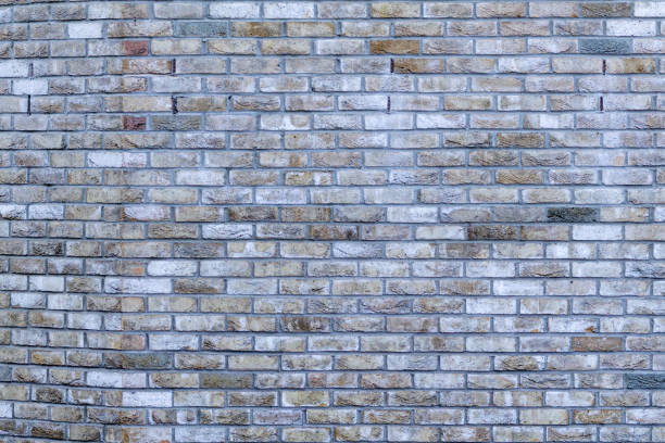 istock Light brown and gray stone wall with light grout. Beautiful old stone pattern, background. Wallpaper 2171760157