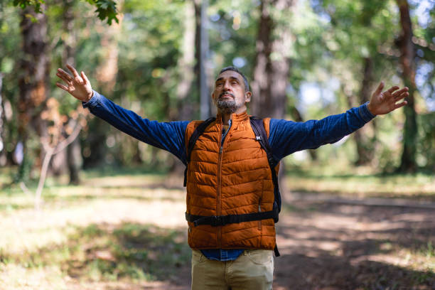 istock Excited man stretches arms in forest environment joy. 2171760897