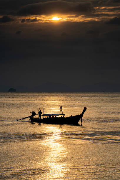 istock Longtail boat in thailand golden sea 2171761826
