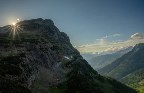 Late Day Sunburst Over Mount Overlin In Glacier