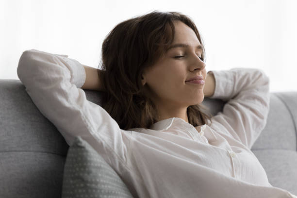 istock Closeup young calm woman relaxing leaned on soft comfortable sofa 2171771749