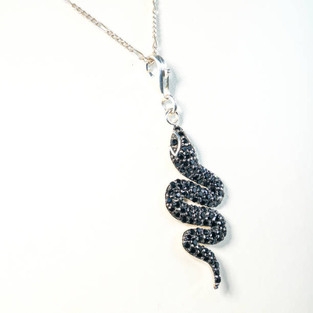 Pendant with a coiled snake symbol