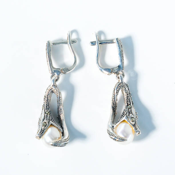 Earrings with two small snake heads symbol
