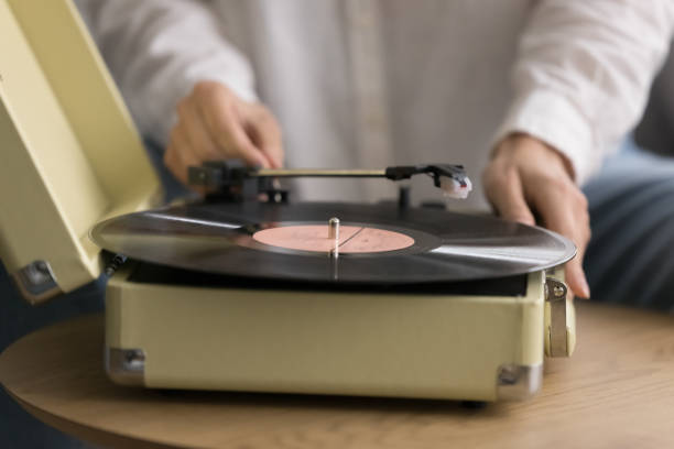 istock Classical music lover plays vinyl record on turntable, closeup 2171772867