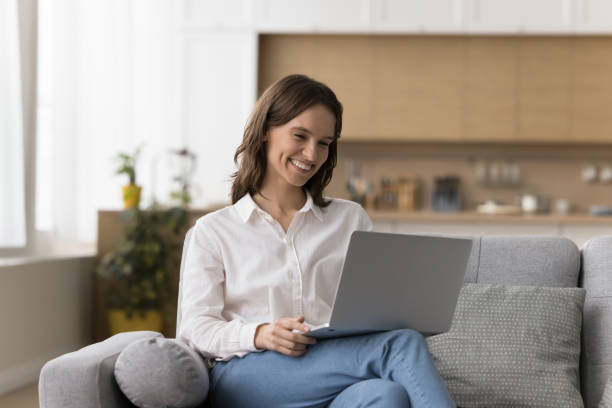 istock Woman sit on sofa working on laptop 2171775434